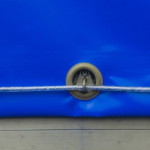 Blue tarps secured using grommets