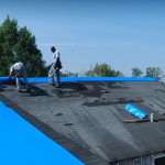 Installing roof tarps during renovation.